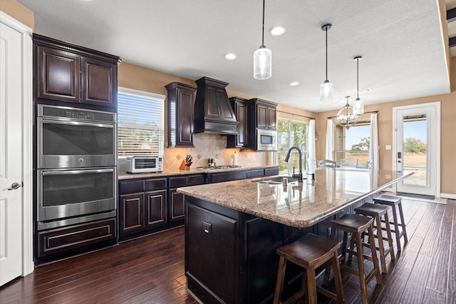 kitchen featuring a wealth of natural light, sink, a kitchen island with sink, and stainless steel appliances