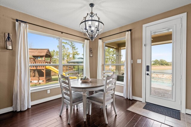 dining room featuring dark wood-type flooring and a notable chandelier