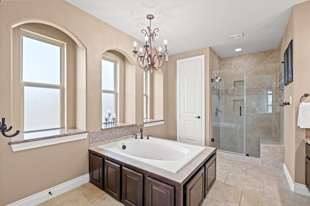 bathroom with vanity, shower with separate bathtub, and a notable chandelier