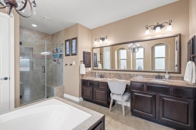 bathroom featuring vanity, tile patterned flooring, and plus walk in shower