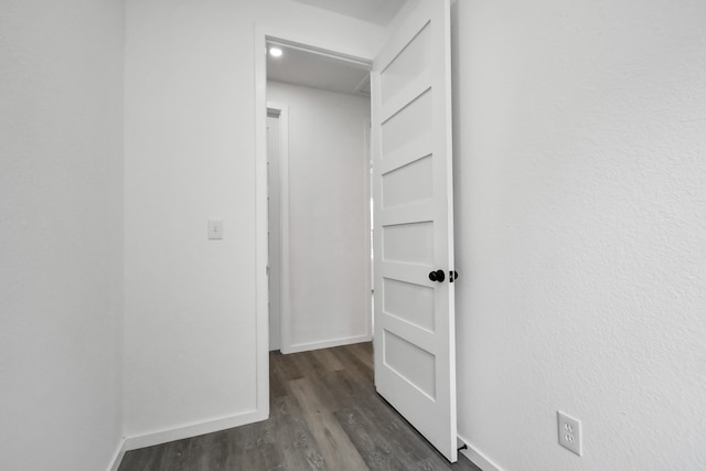 corridor featuring dark wood-type flooring