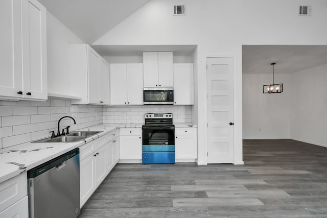 kitchen with white cabinetry, sink, light stone counters, and stainless steel appliances