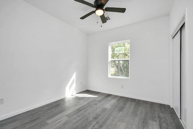 unfurnished bedroom with a closet, ceiling fan, and dark hardwood / wood-style floors