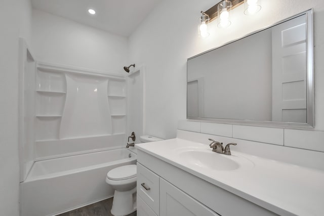 full bathroom featuring vanity, hardwood / wood-style flooring, toilet, and bathtub / shower combination