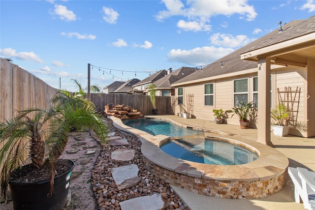 view of swimming pool with an in ground hot tub