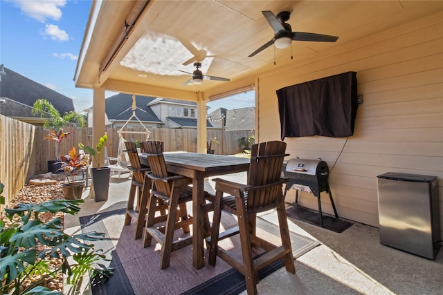 view of patio with a grill and ceiling fan