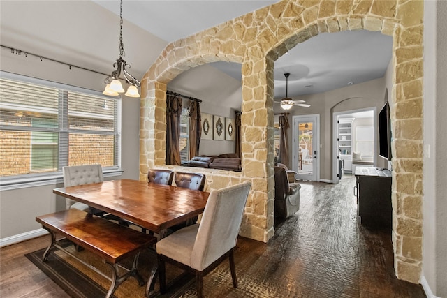 dining room featuring hardwood / wood-style flooring, vaulted ceiling, and ceiling fan