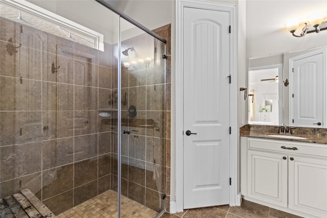 bathroom featuring ceiling fan, tile patterned flooring, vanity, and walk in shower