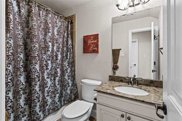 bathroom with vanity, toilet, and walk in shower