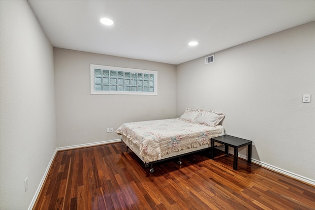 bedroom with dark wood-type flooring