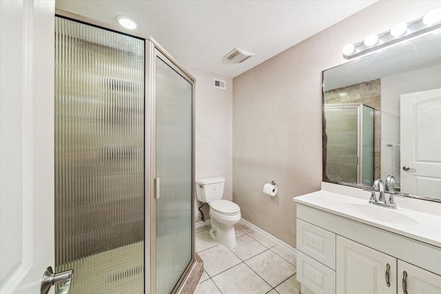 bathroom with walk in shower, tile patterned floors, a textured ceiling, toilet, and vanity