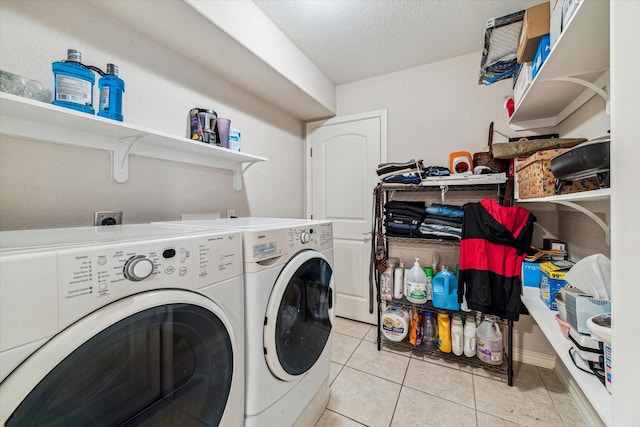 3227 Audley St, Houston, TX 77098 - laundry area featuring separate washer and dryer, light tile patterned floors, and a textured ceiling