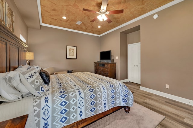 bedroom with ceiling fan, ornamental molding, and hardwood / wood-style floors