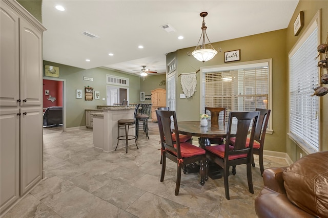 dining area with a wealth of natural light and ceiling fan