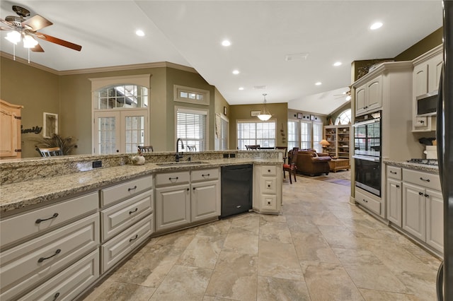 kitchen with black appliances, sink, ceiling fan, vaulted ceiling, and light stone counters