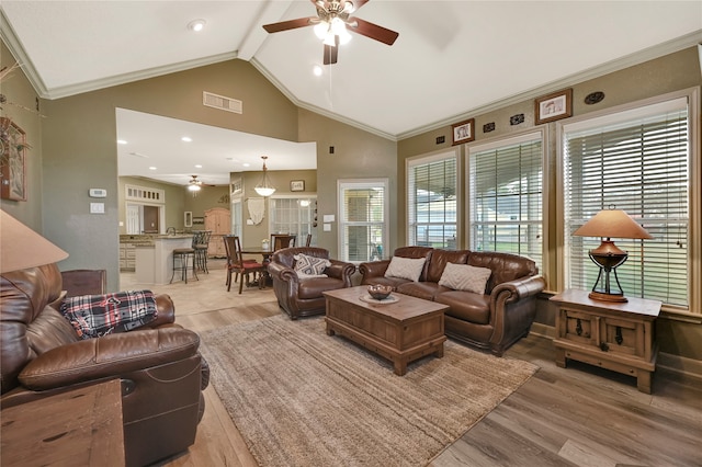 living room with light hardwood / wood-style floors, vaulted ceiling with beams, and ceiling fan