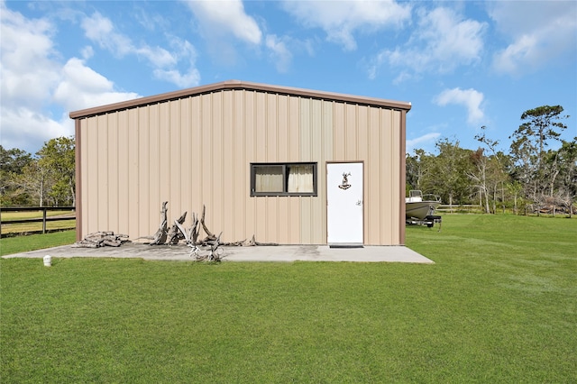 view of outbuilding with a lawn