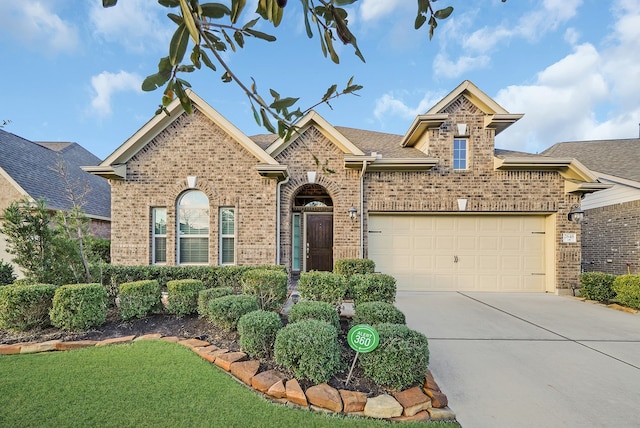 view of front property featuring a garage and a front lawn