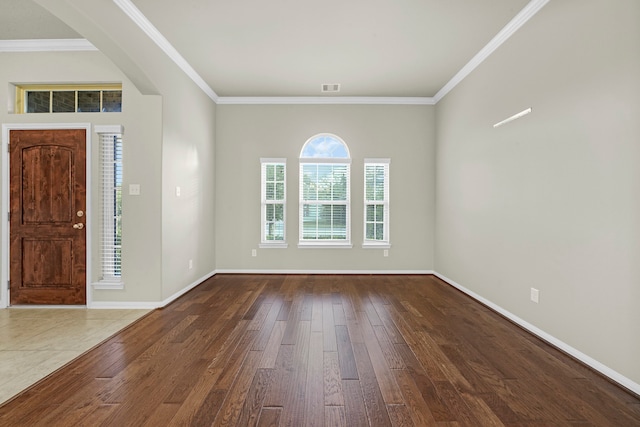 foyer entrance with ornamental molding and hardwood / wood-style flooring