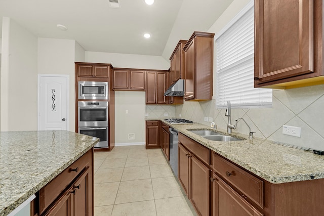 kitchen featuring sink, light tile patterned floors, appliances with stainless steel finishes, light stone counters, and tasteful backsplash