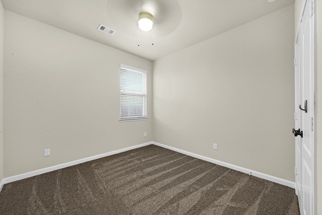 empty room featuring carpet floors and ceiling fan