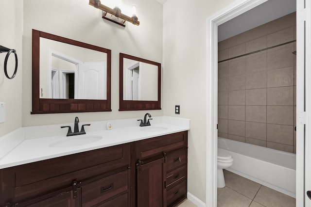 full bathroom featuring toilet, tiled shower / bath, vanity, and tile patterned floors