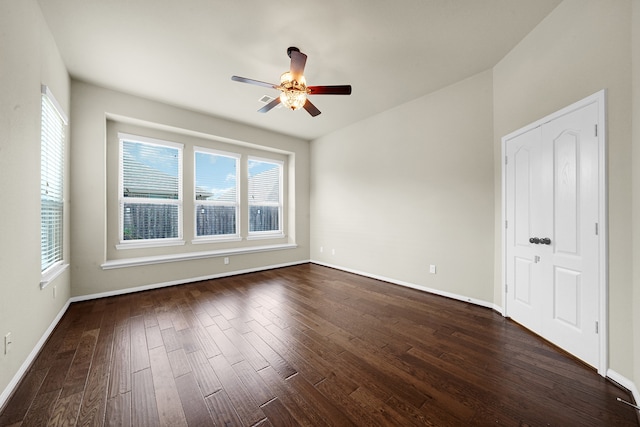 unfurnished room with dark wood-type flooring and ceiling fan