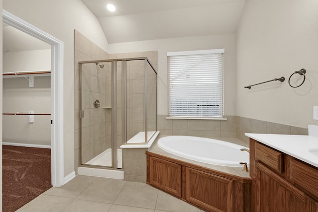 bathroom featuring tile patterned flooring, lofted ceiling, shower with separate bathtub, and vanity