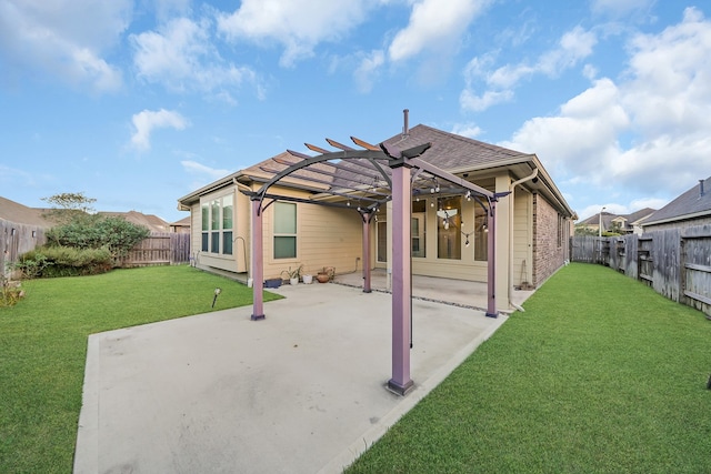 back of property featuring a yard, a patio, and a pergola