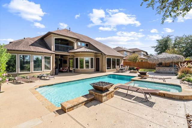 view of swimming pool featuring a patio and a hot tub