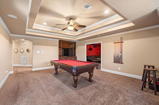 playroom with ceiling fan, ornamental molding, and a tray ceiling