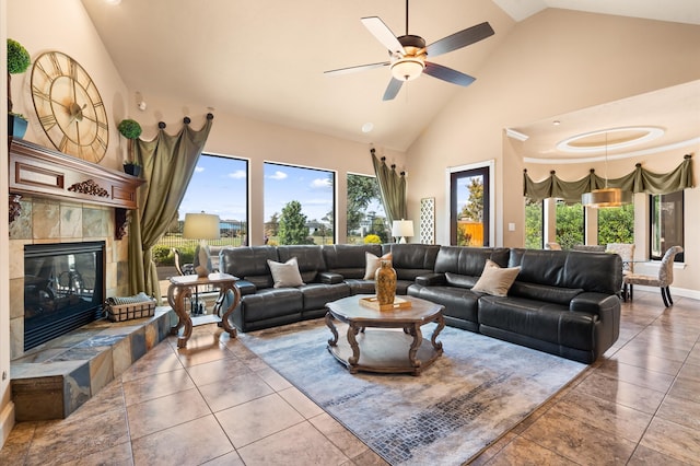 tiled living room with high vaulted ceiling, a tile fireplace, and ceiling fan