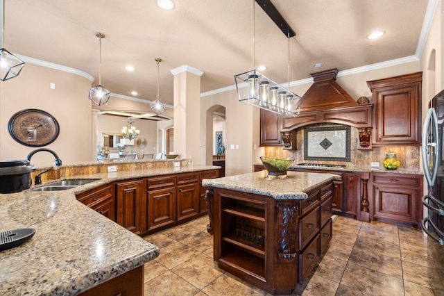 kitchen featuring sink, pendant lighting, and a kitchen island