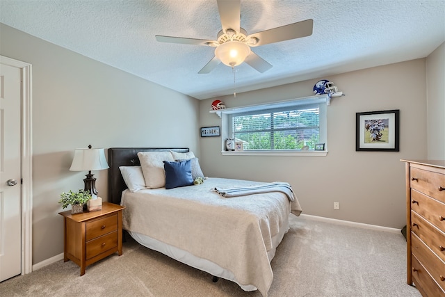 carpeted bedroom with a textured ceiling and ceiling fan