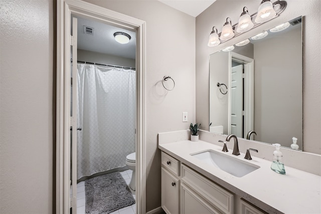 bathroom featuring vanity, toilet, and tile patterned floors