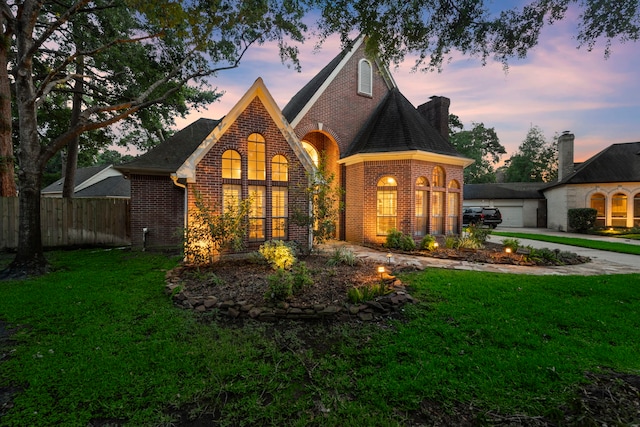 view of front facade with a garage and a lawn