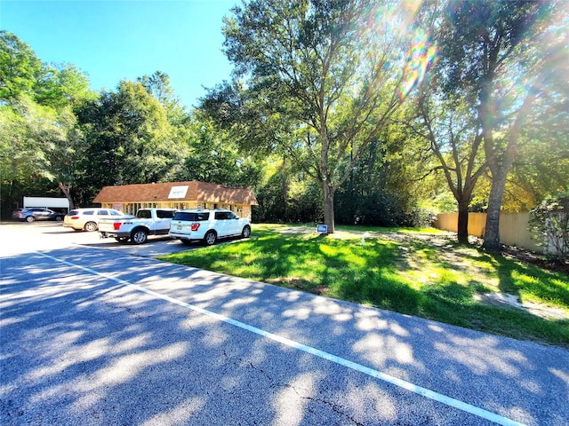 view of parking featuring a lawn