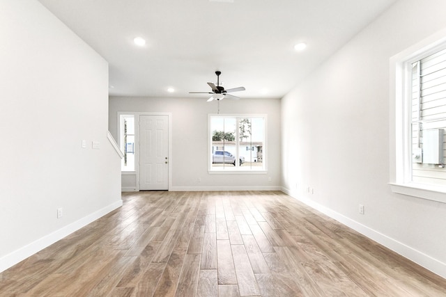 unfurnished living room featuring recessed lighting, light wood-type flooring, a ceiling fan, and baseboards