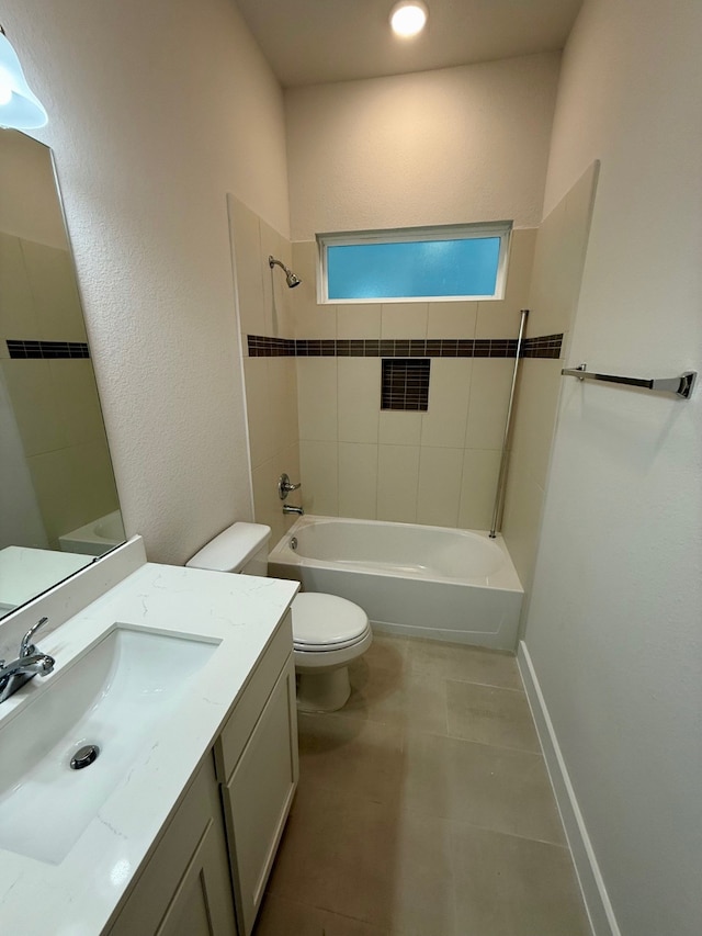 full bathroom featuring tile patterned flooring, tiled shower / bath combo, toilet, and vanity