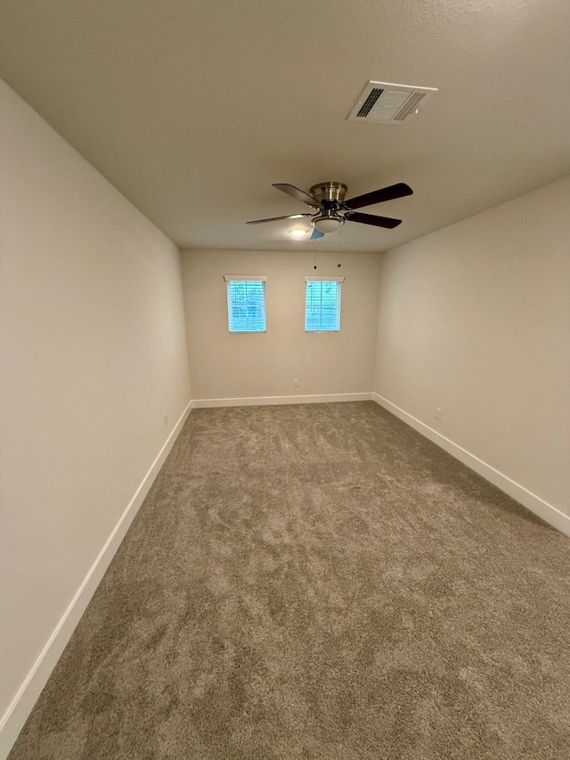 empty room featuring carpet flooring and ceiling fan