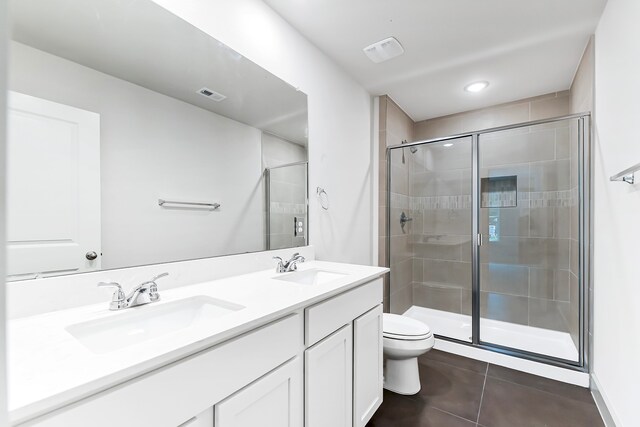 bathroom with walk in shower, vanity, tile patterned floors, and toilet