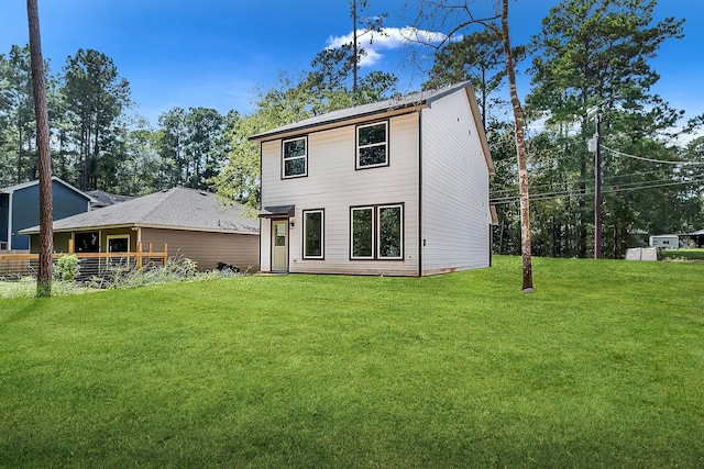 rear view of property with a lawn