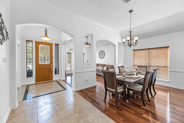 dining space with ornamental molding, light wood-type flooring, and ceiling fan