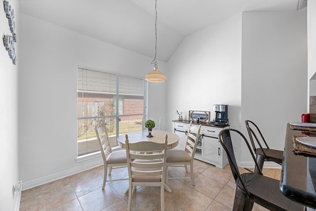 dining space with lofted ceiling and light tile patterned floors