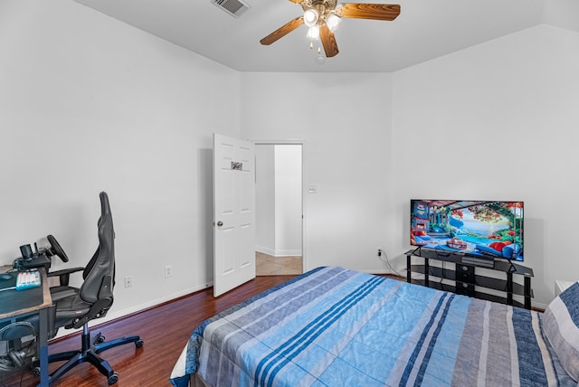 bedroom with wood-type flooring, vaulted ceiling, and ceiling fan