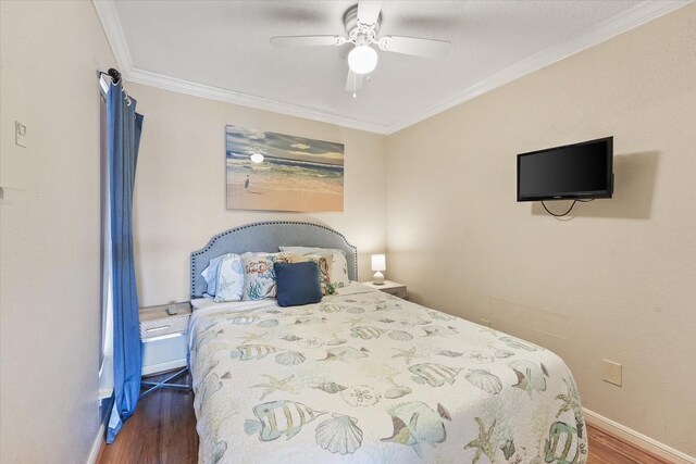 bedroom with dark hardwood / wood-style floors, ceiling fan, and ornamental molding