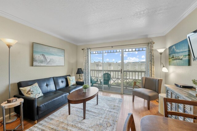 living room with crown molding, hardwood / wood-style floors, and a textured ceiling