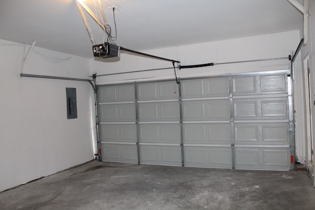 garage with a garage door opener and electric panel