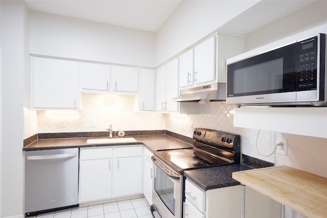 kitchen with stainless steel appliances, decorative backsplash, sink, and white cabinets