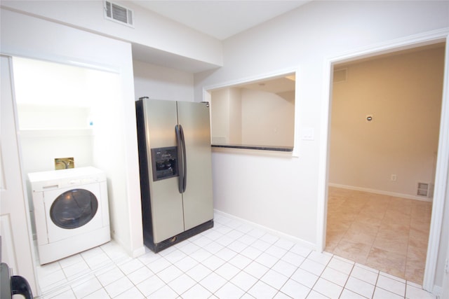 laundry room featuring light tile patterned floors and washer / clothes dryer